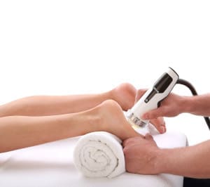 A person receiving a foot scan using a handheld device.
